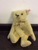 Steiff: A teddy bear with gilt bow numbered 662539