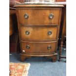 A mahogany bow front chest of three drawers.