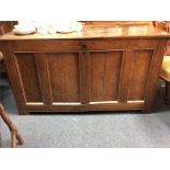 An Antique oak panelled coffer.