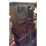 An oak glazed two part bookcase.