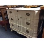 A painted pine serpentine fronted chest.