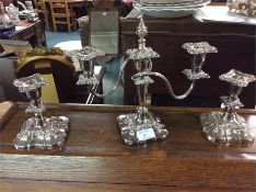 A plated candelabra together with matching candles