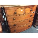 A small mahogany bow front chest of five drawers.