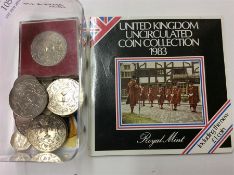 A box containing old commemorative coins etc.