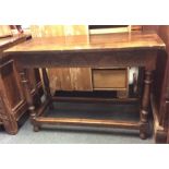 A small oak carved refectory table with stretcher