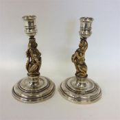 A pair of heavy cast Coronation candlesticks mount