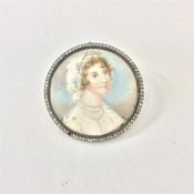 A circular watercolour of a lady in paste frame an