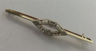 A gold and platinum bar brooch mounted with seed p
