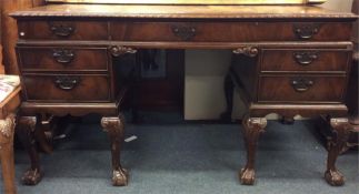 A mahogany twin pedestal seven drawer desk on ball