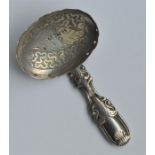 An Antique caddy spoon with embossed handle and en
