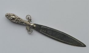 A small silver bookmark in the form of a sword wit