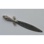 A small silver bookmark in the form of a sword wit