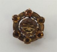 A Scottish gold and orange stone brooch with engra