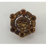 A Scottish gold and orange stone brooch with engra