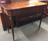 An Antique mahogany hinged top tea table on fluted
