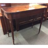 An Antique mahogany hinged top tea table on fluted