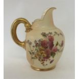 ROYAL WORCESTER: A gilded ewer with flower decorat
