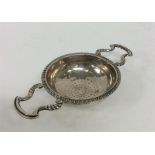A rare and unusual two-handled lemon strainer with