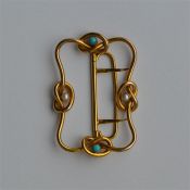 A gold pearl and turquoise buckle with know decora