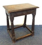 A small oak carved coffin stool on stretcher base.