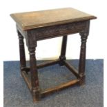 A small oak carved coffin stool on stretcher base.