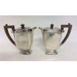 A pair of stylish hot water pots with cut corners