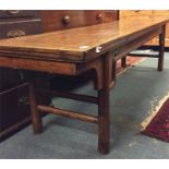 An Antique elm wood bench with stretcher base. App