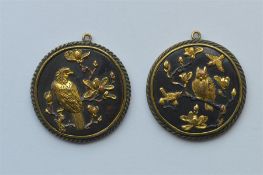 A pair of unusual Shakudo pendants depicting wild