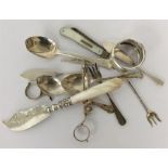 A bag containing silver butter knife, napkin ring,