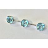 A 9 carat blue stone brooch in rubover mount. Appr