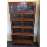 A mahogany five stack lead glazed bookcase on brac