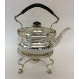 A large half fluted kettle on stand with scroll de