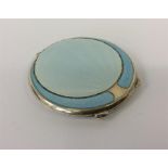 A blue enamel compact with flower decoration, fitt