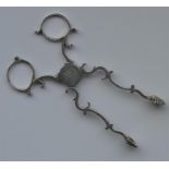 A pair of Georgian scissor action tongs with crest
