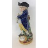 A brightly coloured Toby jug of a gent on circular