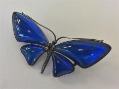 A silver butterfly wing brooch in the form of a bu