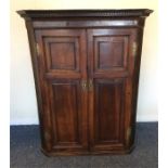 A Georgian mahogany corner cupboard with dental fr