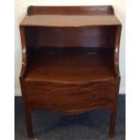 A Georgian mahogany bow front commode with hinged