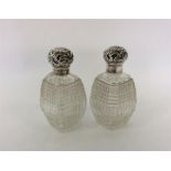 A pair of silver hobnail cut scent bottles with em
