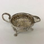 An unusual cream jug inset with coin and hairy fee
