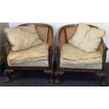 A pair of Bergère chairs on hairy ball and claw fe