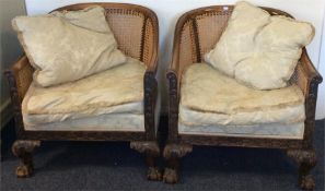 A pair of Bergère chairs on hairy ball and claw fe