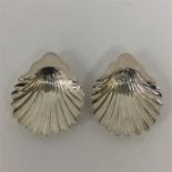 A pair of shell shaped salts with fluted bowls. Lo
