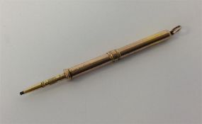A small gold extending pencil with loop top and sl