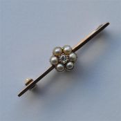 A pearl and diamond brooch in the form of a cluste
