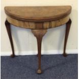 A bow fronted tilt top card table on cabriole legs