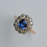 An attractive oval sapphire and diamond daisy head