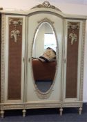 A good French painted triple wardrobe with mirrore