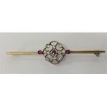 A long gold brooch with openwork decoration. Appro