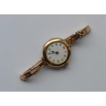 A lady's 9 carat wristwatch with white enamelled d